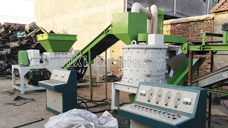 View of the radiator crusher and control panels in the recycling line.