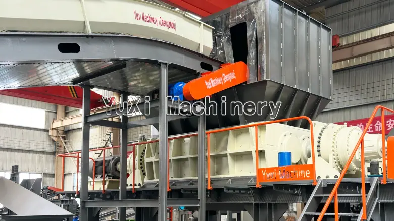 Large industrial shredder with a wide hopper for processing appliances.