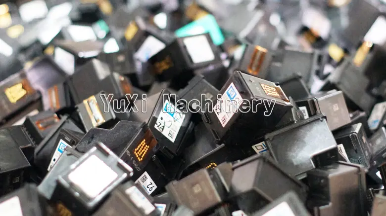 Close-up view of piles of waste printer ink cartridges ready for recycling.