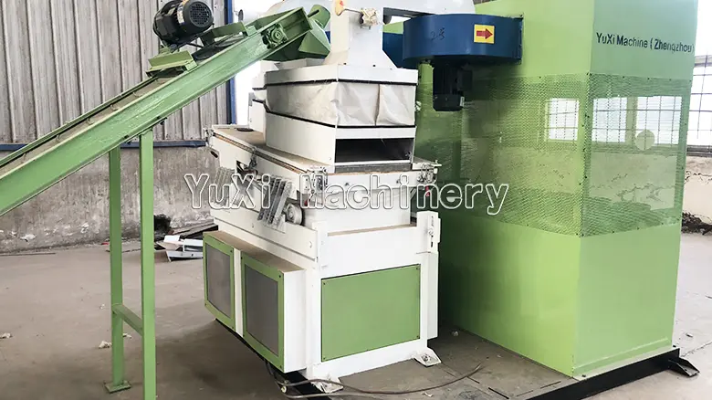 Side view of the gravity separator connected to an inclined feeding conveyor belt for material input.