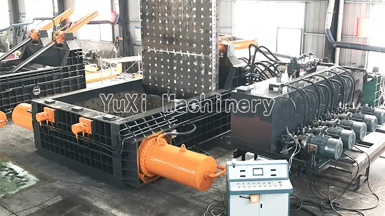 Large Scale Metal Baler System Large metal baler on a factory floor with its hydraulic power unit and control panel visible.